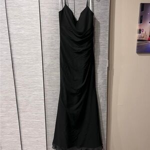 Selling black long bridesmaid dress. Has never been worn or altered.